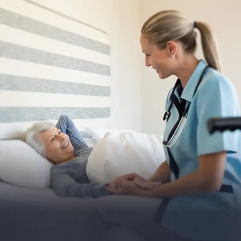 Nurse sitting on an older patients bedside